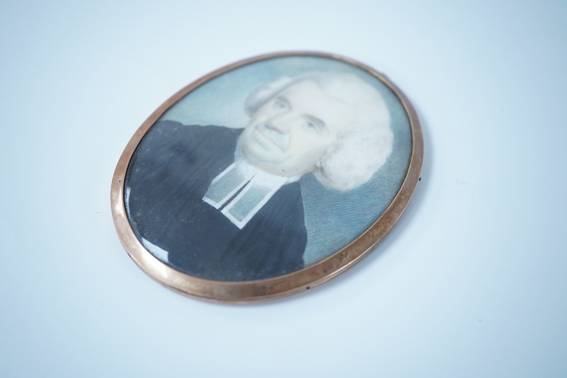 An early 19th century, English School, Portrait of a clergyman, portrait miniature, watercolour on ivory, housed in a gilt metal frame, 7.5cm high CITES Submission reference 2DG4HQ4U